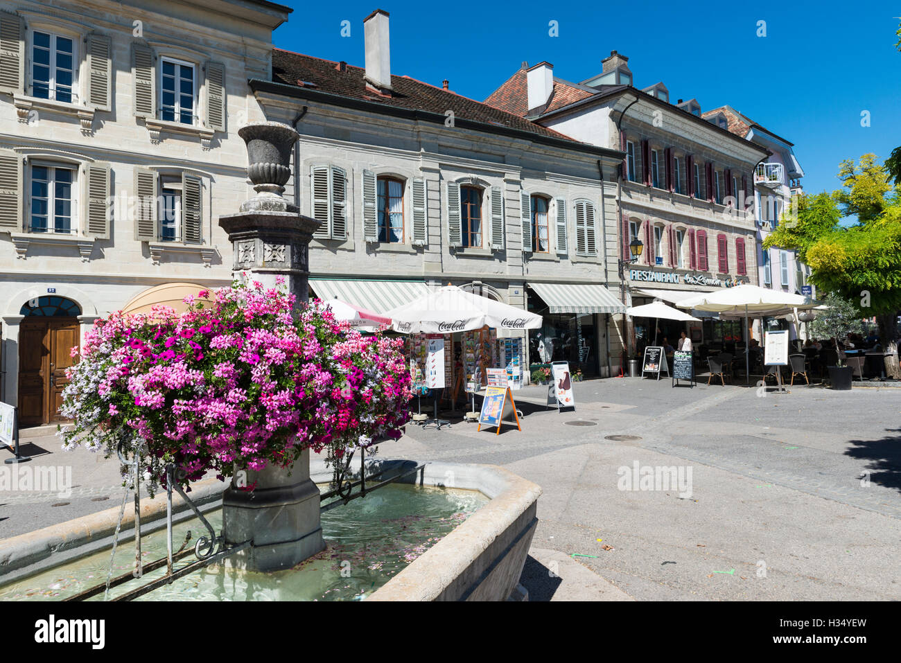 Fontana con fiori, Rue de Rive, Nyon, canton Vaud, Svizzera Foto Stock