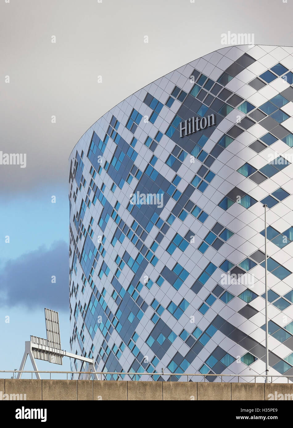 Particolare della facciata esterna con hotel di digital signage e autostrada. Hilton Amsterdam Airport Schiphol, Amsterdam, Paesi Bassi. Architetto: Mecanoo architects, 2015. Foto Stock