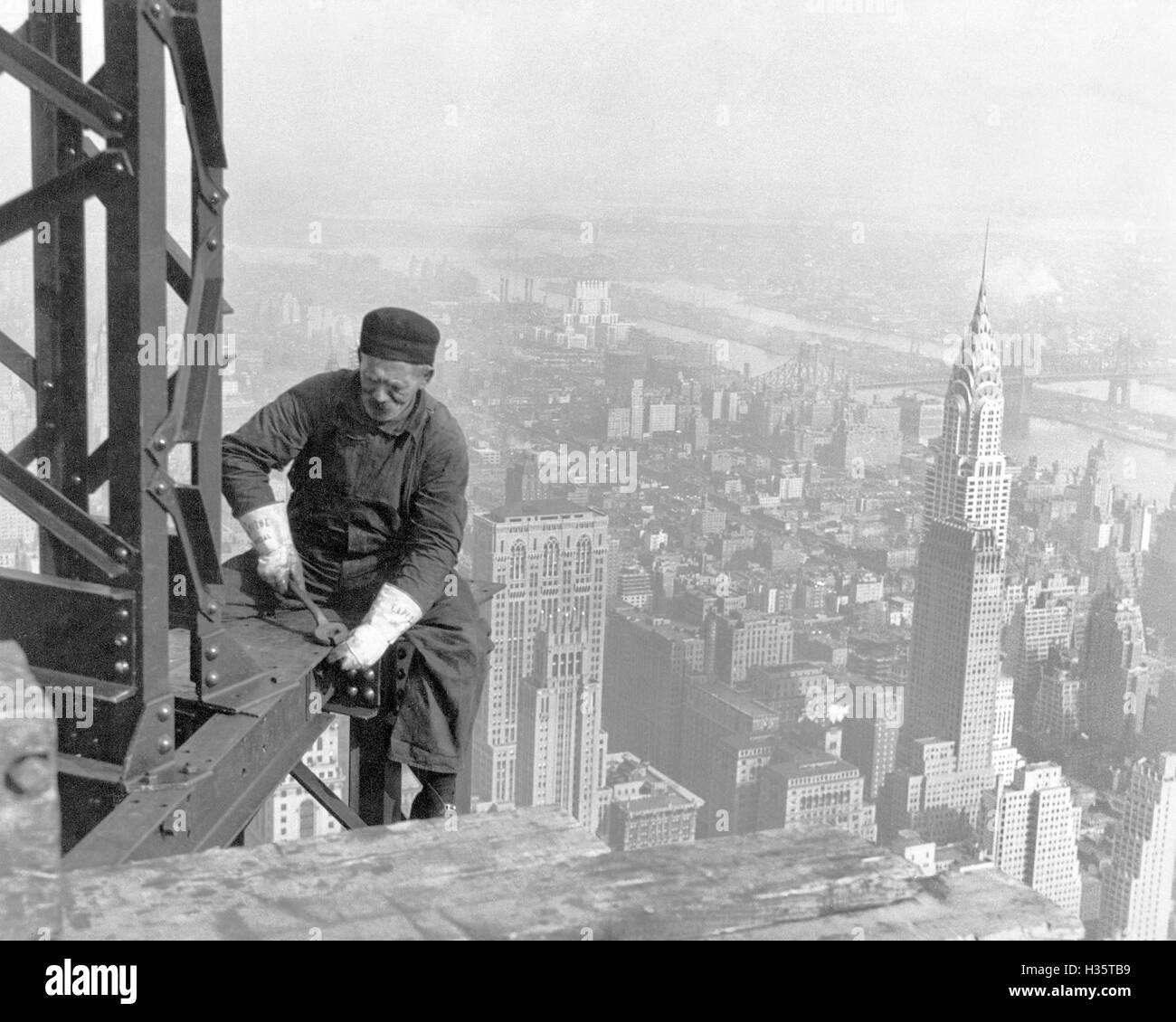 EMPIRE State Building di New York in costruzione nel 1930 con la Chrysler Building a destra Foto Stock