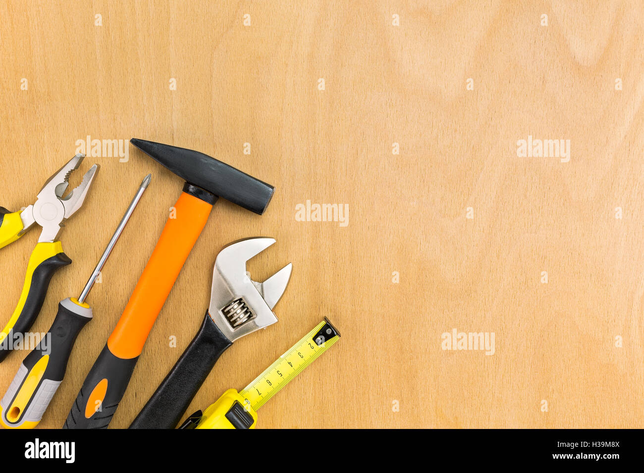 Set di strumenti di lavoro sul pannello di legno sfondo Foto Stock
