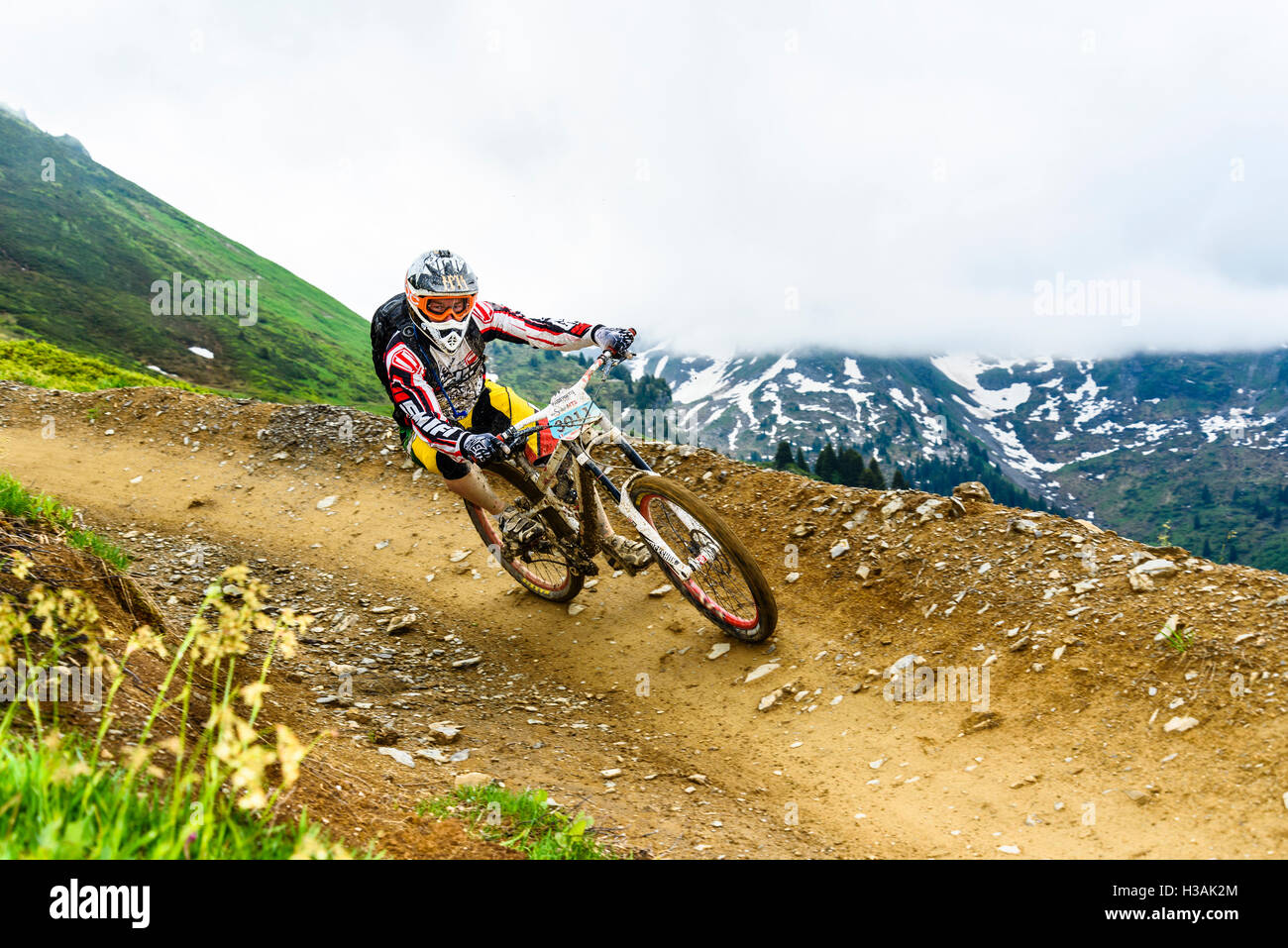 Pilota sul bermed via durante il passaggio"Portes du Soleil 2016 MTB mountain bike evento attraverso il confine franco-svizzero Foto Stock