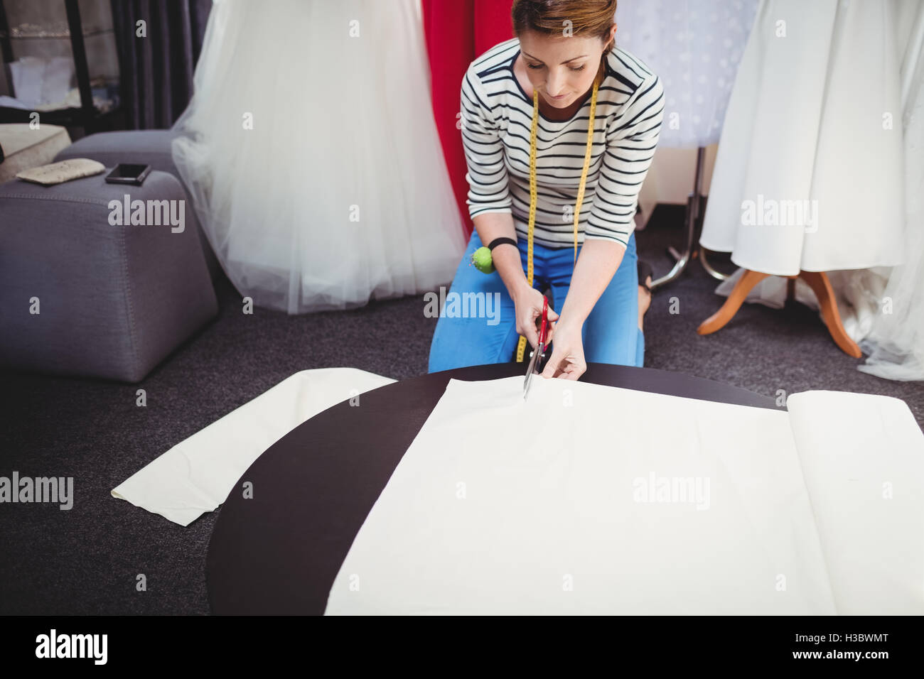 Femmina designer di moda il taglio di un tessuto bianco Foto Stock