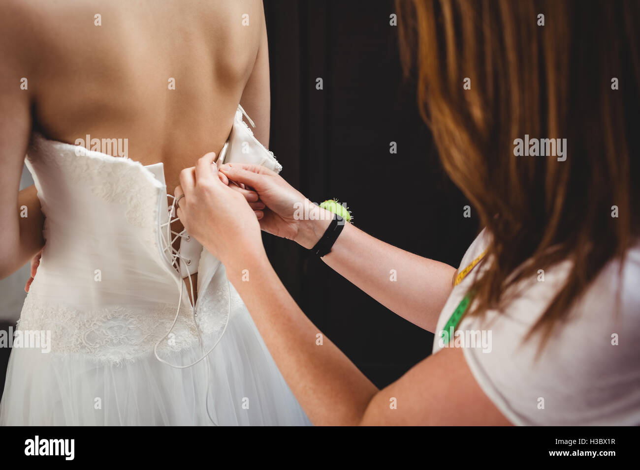 Donna cercando in abito da sposa con il contributo di designer creativo Foto Stock