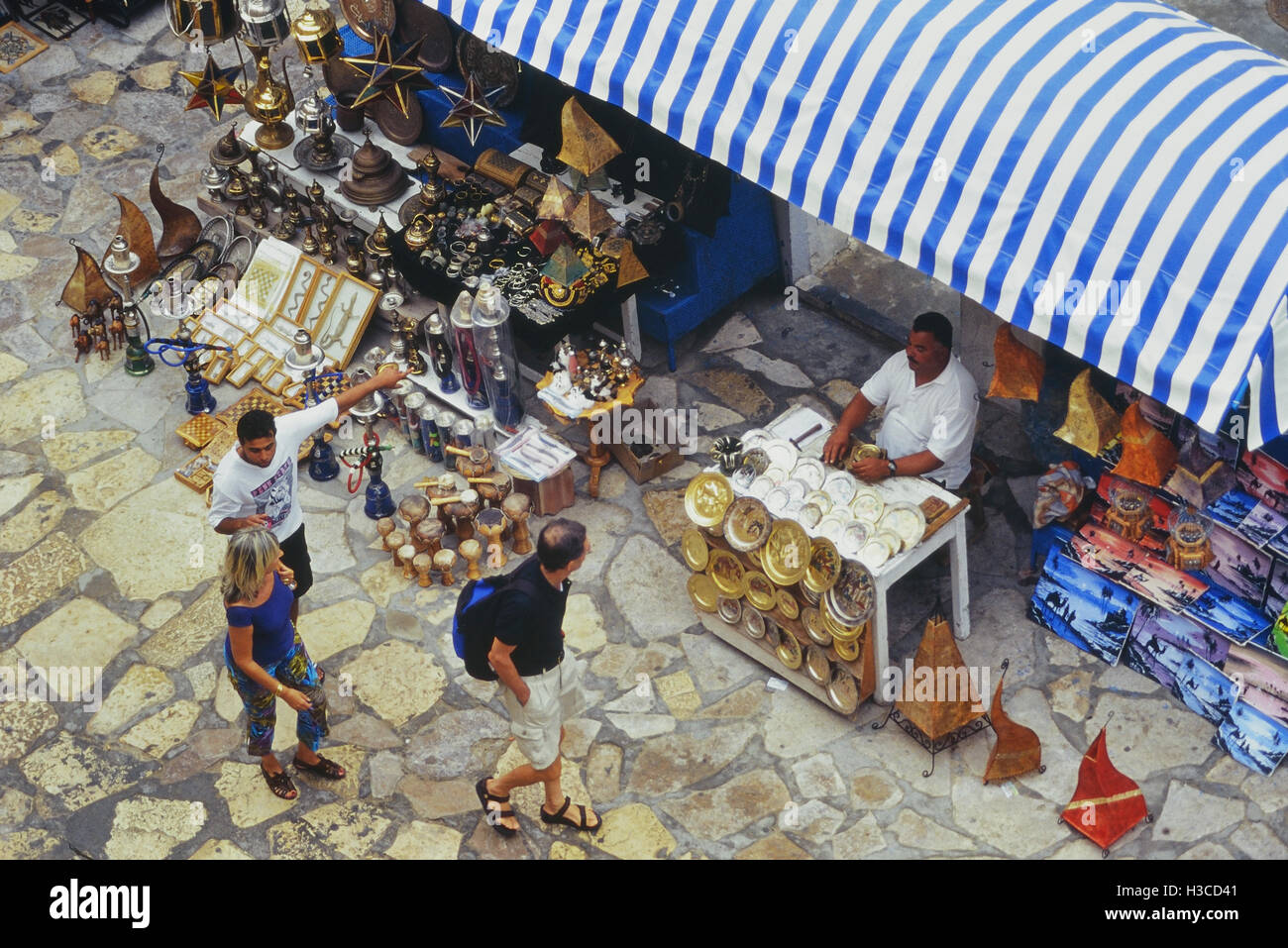 Negoziante cercando di attirare i turisti nel suo negozio. La Medina. Hammamet. La Tunisia Foto Stock