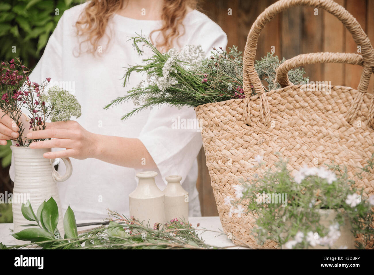 Una donna di preparare una miscela di erbe per cucinare, la scomposizione della lascia fuori per la trinciatura. Foto Stock