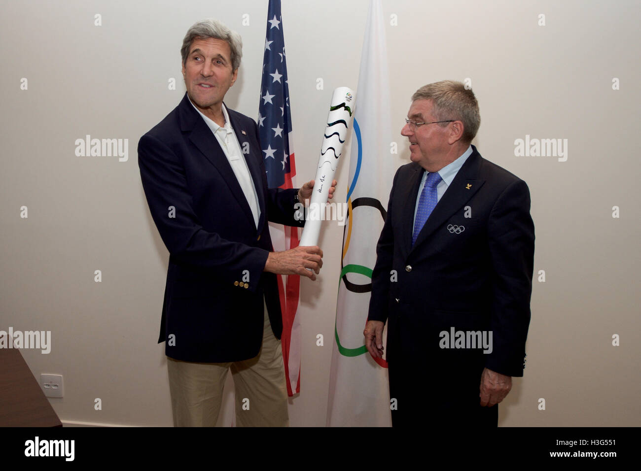 Stati Uniti Il segretario di Stato John Kerry ammira la simulazione di una torcia olimpica a lui presentati dal Comitato olimpico internazionale il presidente Thomas Bach al Parco Olimpico di Rio de Janeiro, Brasile, il 6 agosto 2016, dopo che i due hanno tenuto un incontro mentre il Segretario e i suoi colleghi della U.S. Delegazione presidenziale frequentare i giochi olimpici estivi. Foto Stock