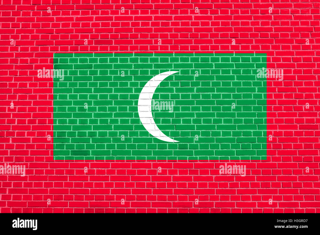 Maldiviano simbolo nazionale. Sfondo patriottico design. Bandiera delle Maldive su un muro di mattoni sfondo texture Foto Stock