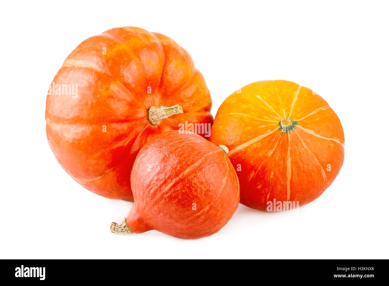 Tre Hokkaido squash su sfondo bianco Foto Stock