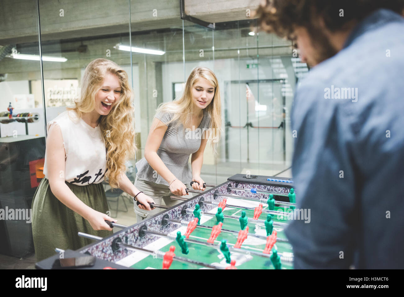 Co-lavoratori a giocare a biliardino a rottura Foto Stock