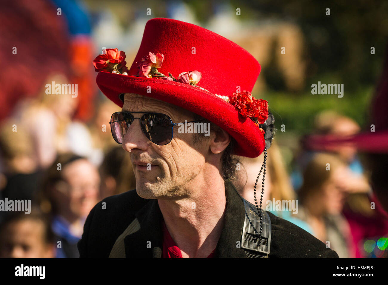 Un uomo che indossa un rosso decorato top hat in Penryn Festival in Cornovaglia Foto Stock