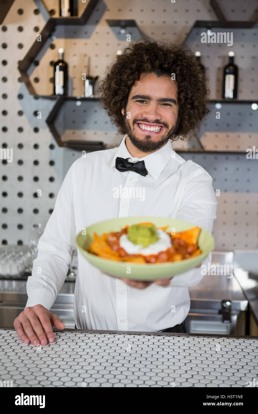 Cameriere ciotola di snack nel bar counter Foto Stock