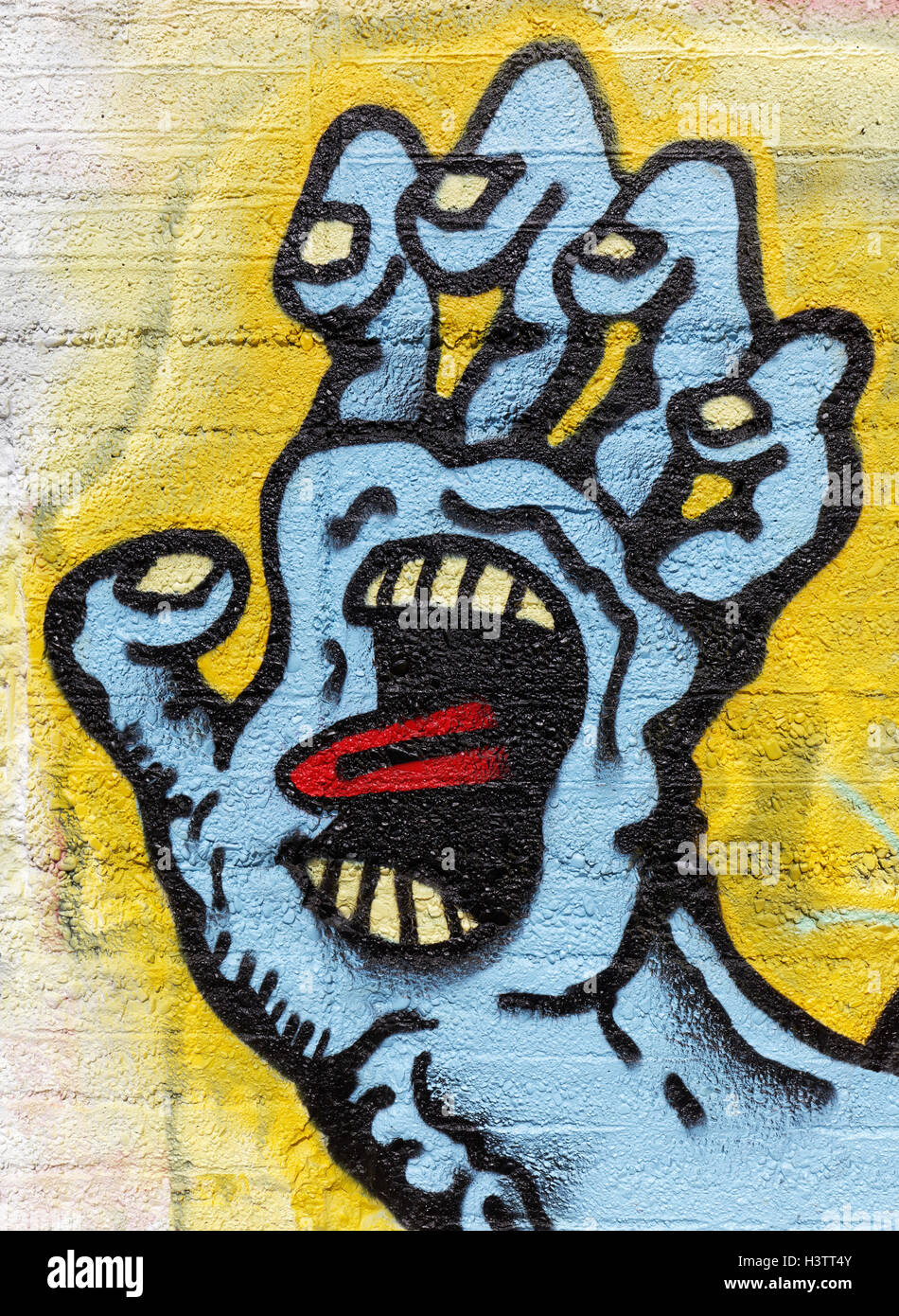 Monster mano, afferrare, faccia in palm, lingua bloccati, simbolici graffiti, arte di strada, Duisburg, Renania settentrionale-Vestfalia Foto Stock
