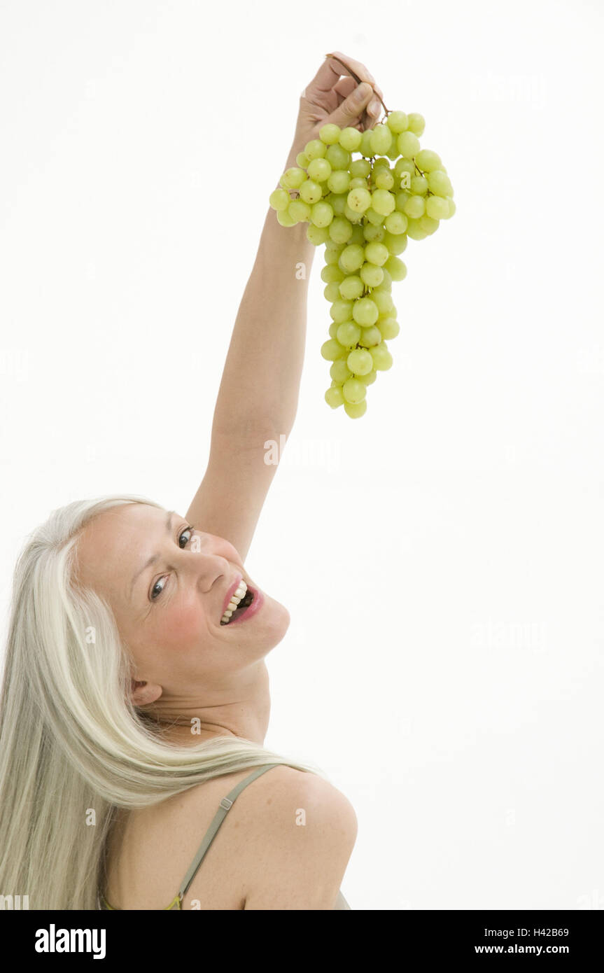 Donna, migliore età, mangiare uva, Foto Stock