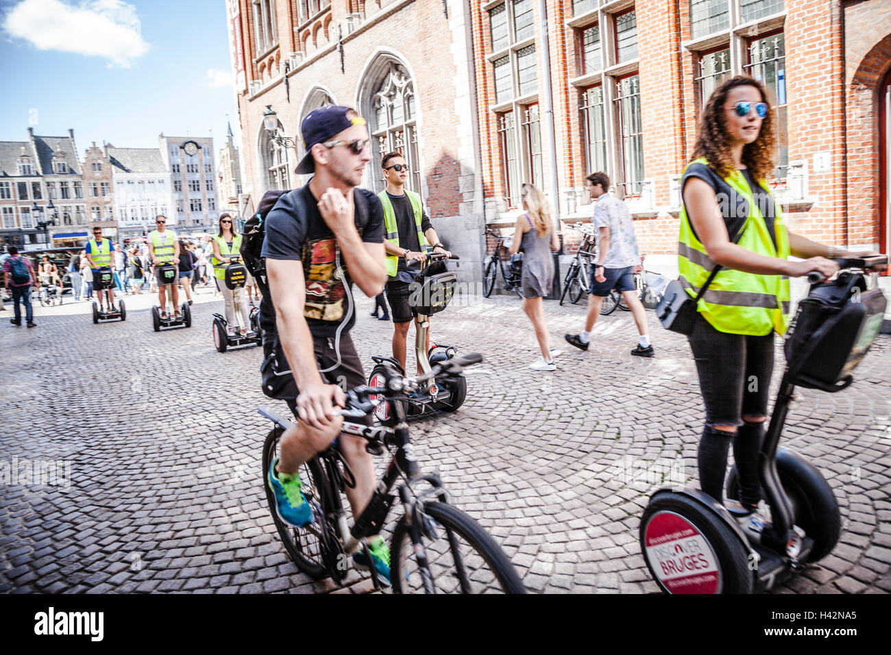 I turisti di marcia Segway per le strade del centro della città di Bruges, Belgio. Foto Stock