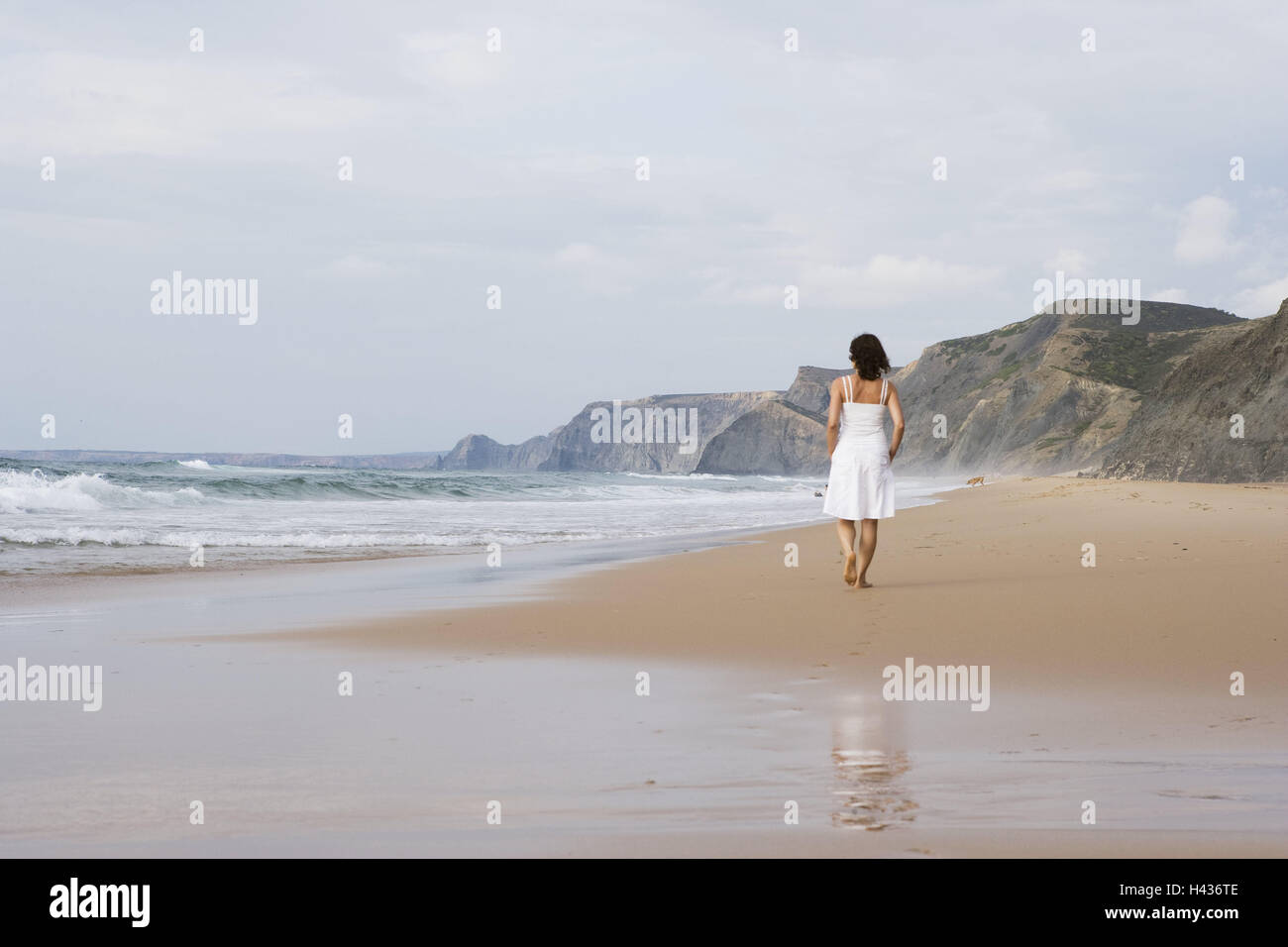 Il Portogallo, spiaggia, donna, abiti estivi, vista posteriore, a piedi, Costa, Costa di bile, spiaggia sabbiosa, rock, mare, acque, persona, giovani, solo, abito, bianco vai, di riposo e di tempo libero, vacanze, riflessione, Foto Stock