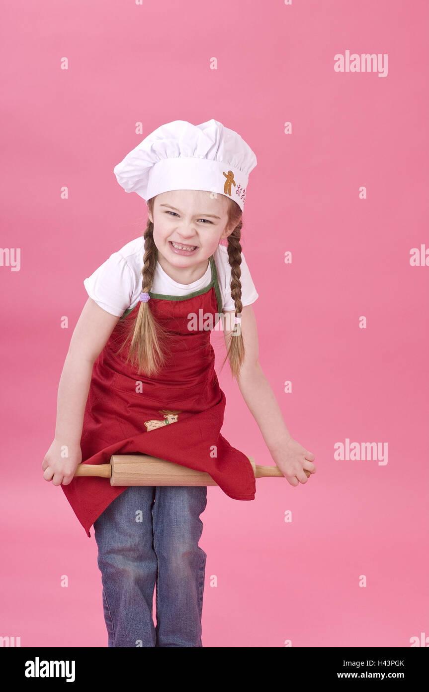 Le ragazze con il mattarello, studio, sfondo rosa, Foto Stock