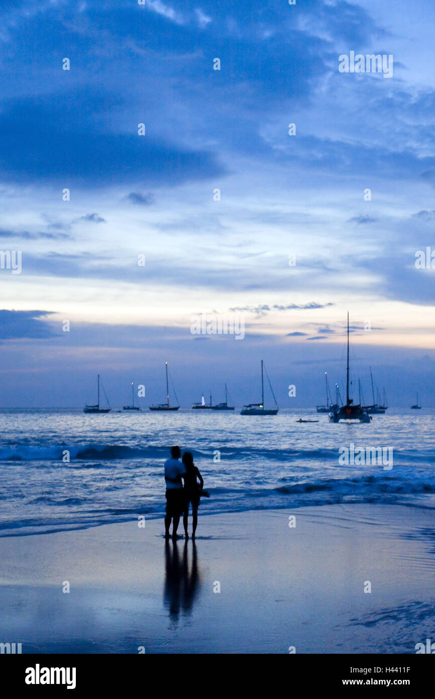 Thailandia Phuket Nai Harn Beach, silhouette, giovane, vista posteriore, crepuscolo, Foto Stock