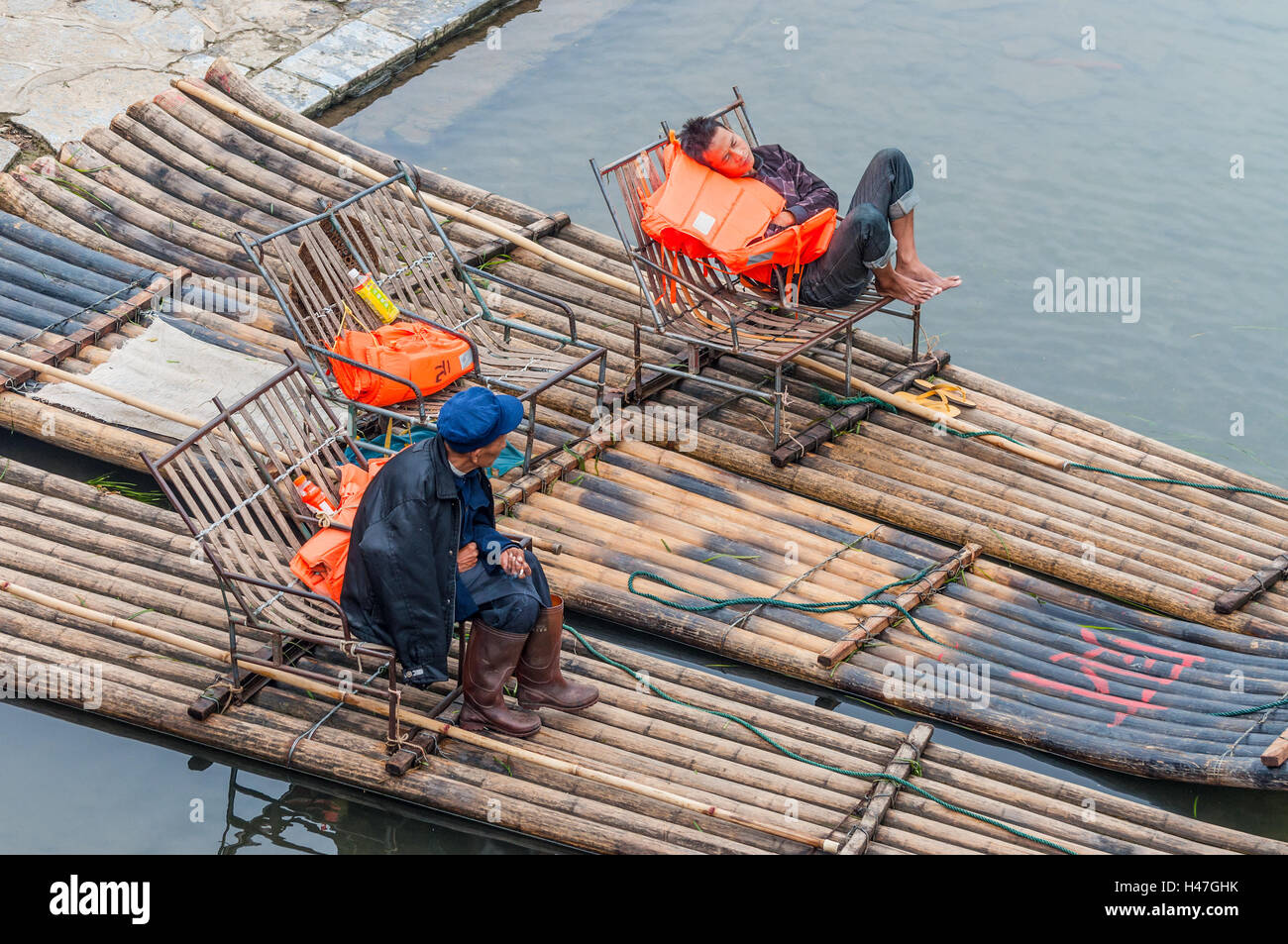 I barcaioli resto in attesa per i turisti sui loro zattera di bambù sulla riva del Fiume Li e Yangshuo Foto Stock