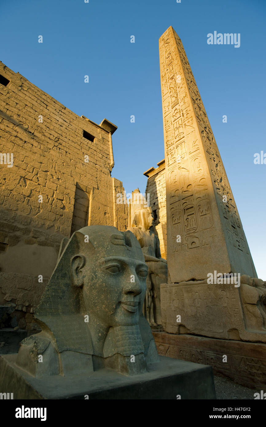 Egitto Luxor tempio di Luxor, testa di statua di Ramses II e obelisco di fronte al pilone, Foto Stock