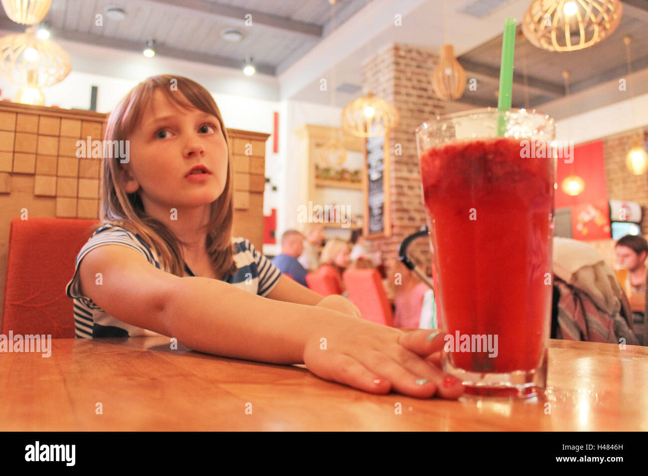 Ragazza giovane beve una limonata in ristorante Foto Stock