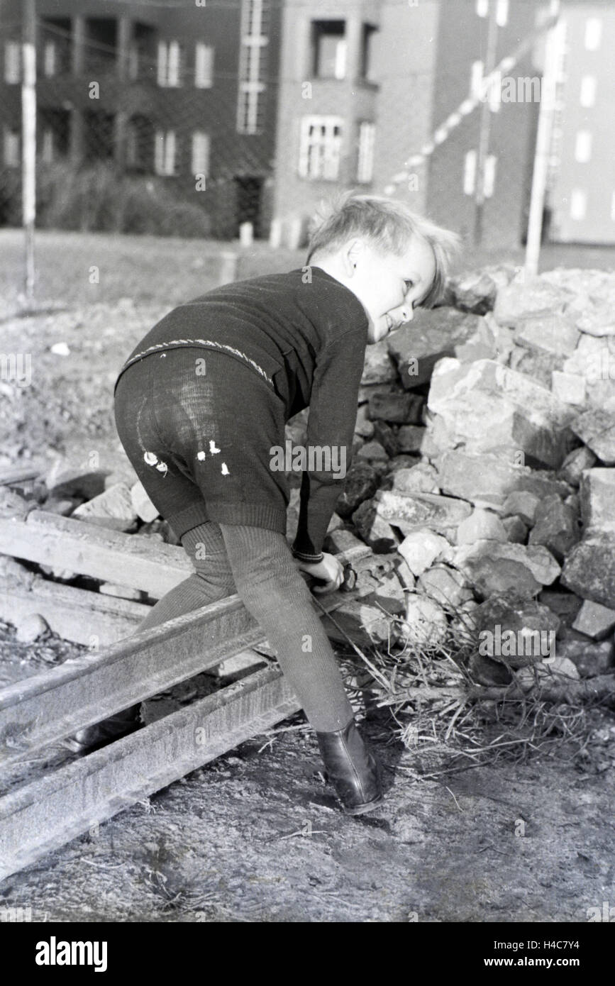 Mitglieder einer kinderreichen Familie spielen hinter dem Wohnhaus, Deutsches Reich 1930er Jahre. I membri di una famiglia estesa giocando dietro l'edificio di appartamenti, Germania 1930 Foto Stock