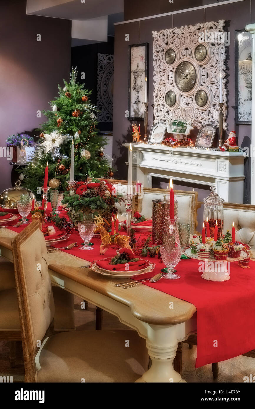 Tabella servita in stanza vuota decorato per il Natale. Tabella di ringraziamento, decorate con freschi di pino e candele. Foto Stock