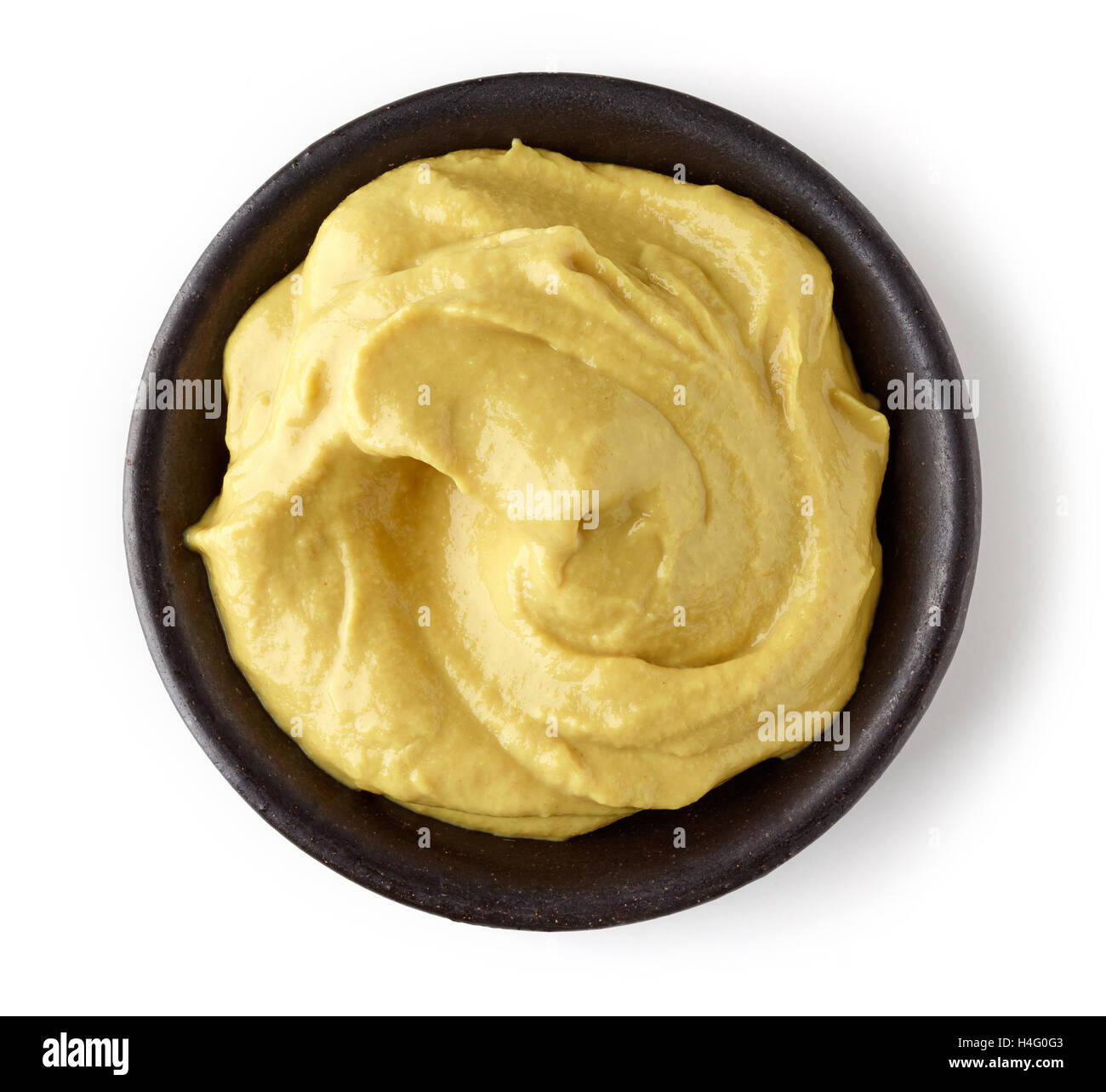 La senape in piatto rotondo isolato su sfondo bianco, vista dall'alto Foto Stock