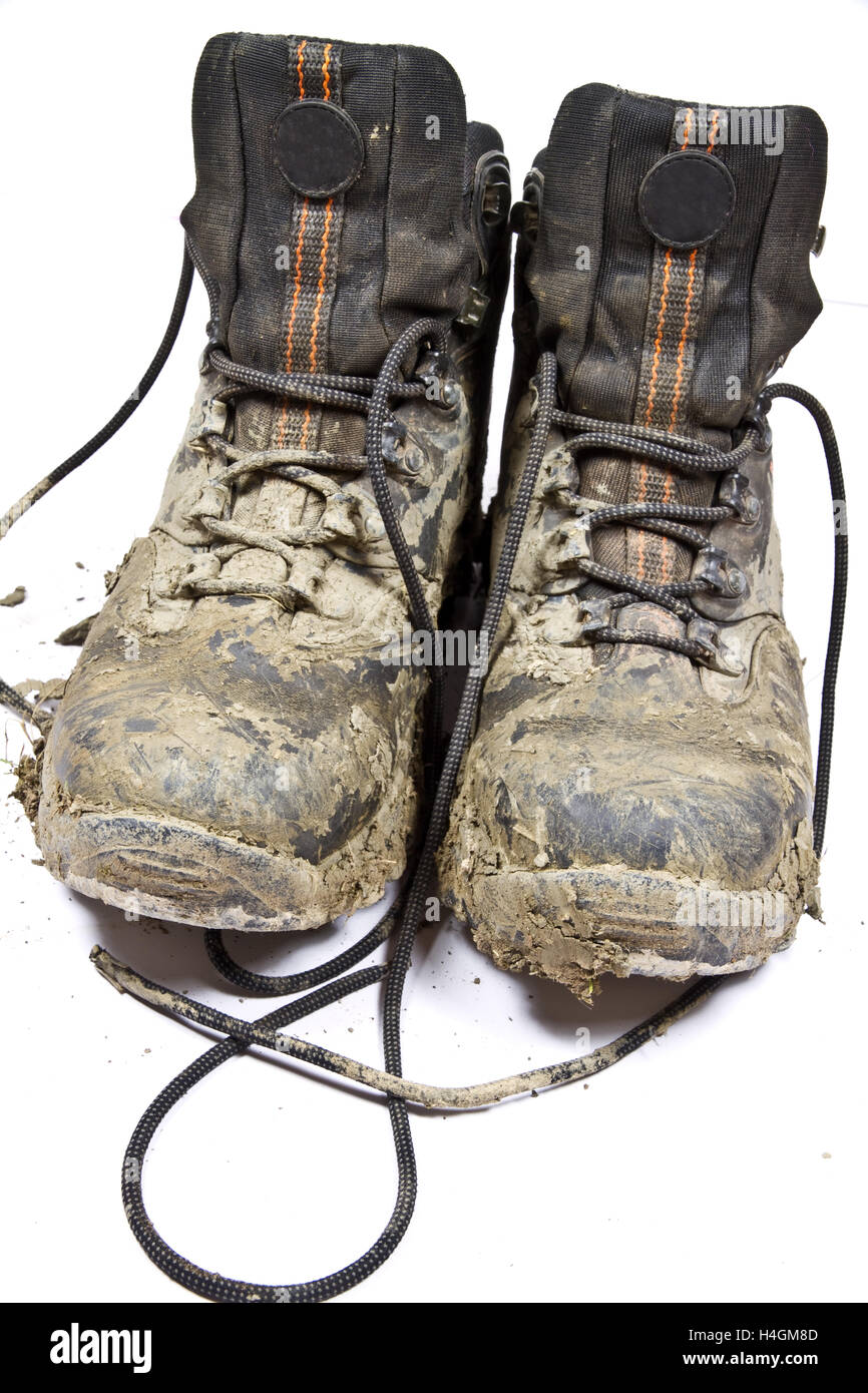 Coppia di terreni fangosi , indossato a piedi o scarponi su uno sfondo semplice Foto Stock