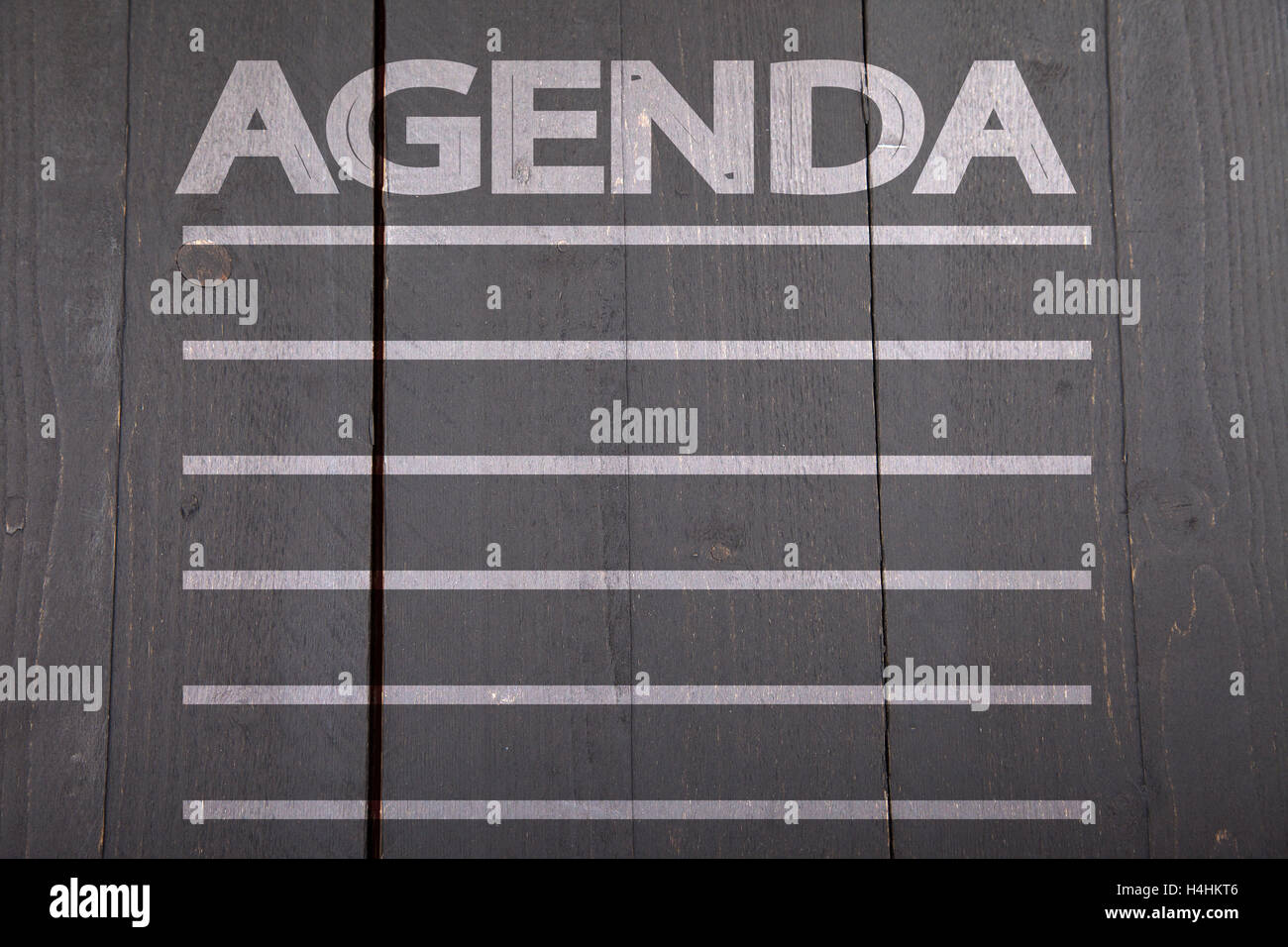 Ordine del giorno sulla lista nera di sfondo di legno Foto Stock