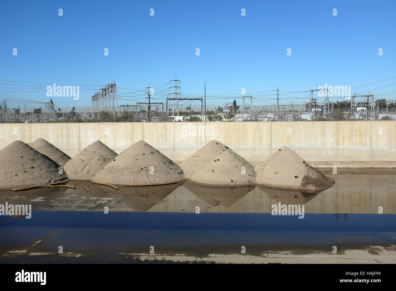 Santa Ana si trova sul fiume Orange County, California, equipaggi sabbia pulita dal calcestruzzo foderato via d'acqua. La sabbia viene recuperato. Foto Stock