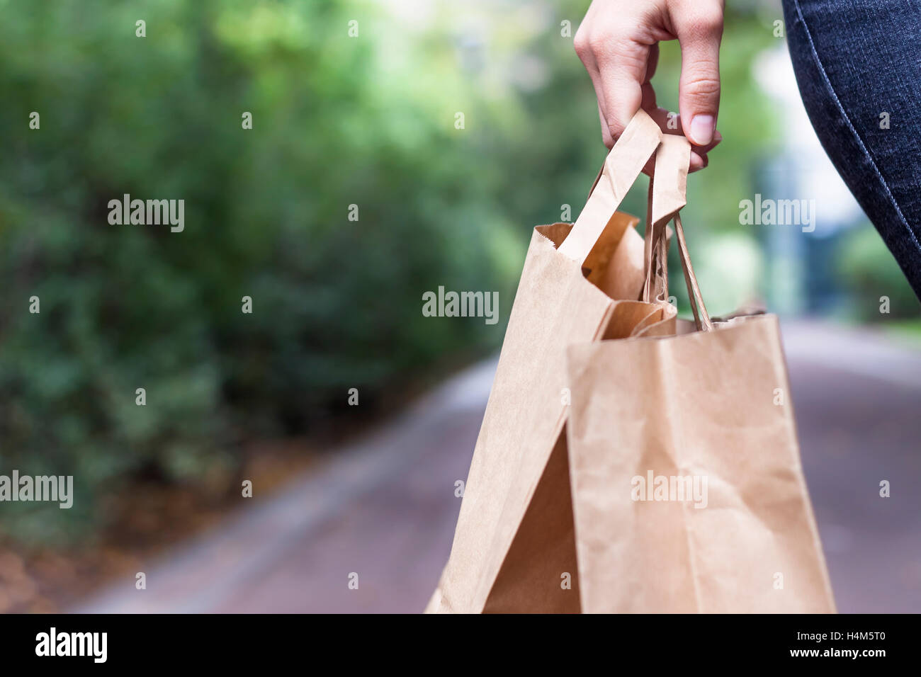 Ragazza facendo shopping ecologico con sacchetti di carta a portata di mano Foto Stock