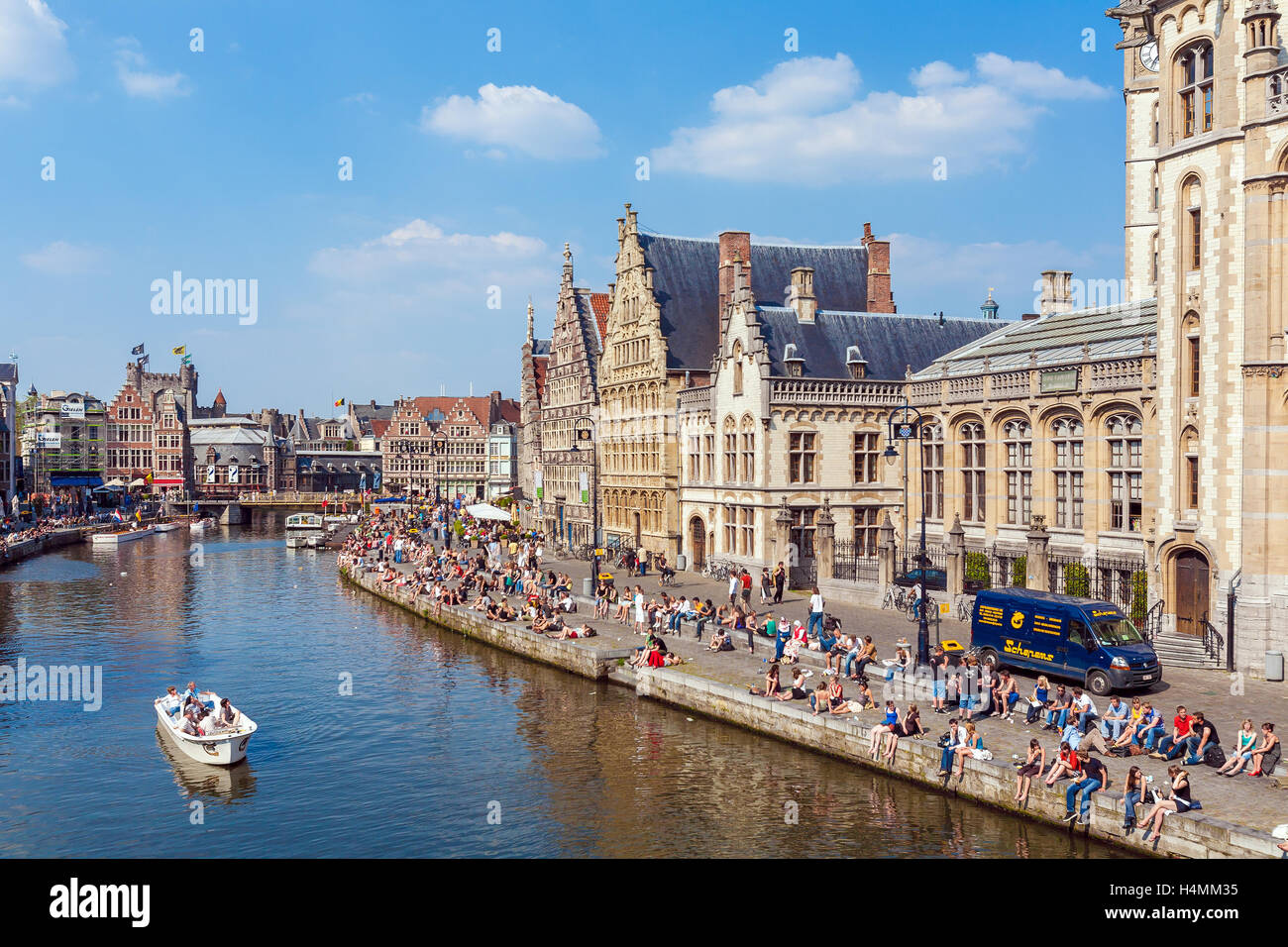 GHENT, Belgio - Aprile 6, 2008: un sacco di studenti seduti sul lungomare del fiume Leie lungo Graslei street Foto Stock