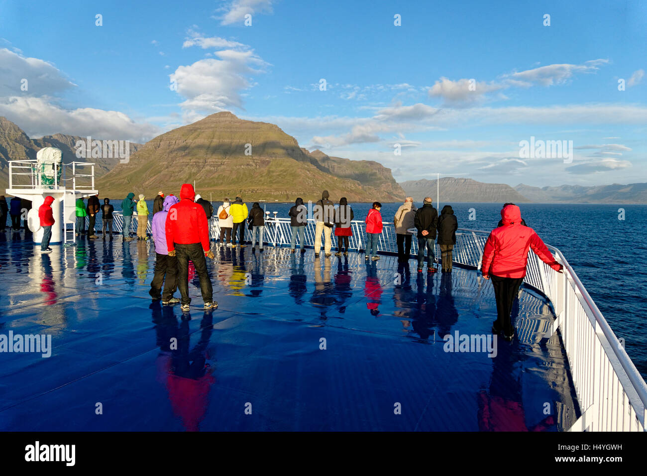 I turisti sul traghetto barca si avvicina il fiordo orientale costa, Islanda, Atlantico del Nord, Europa Foto Stock