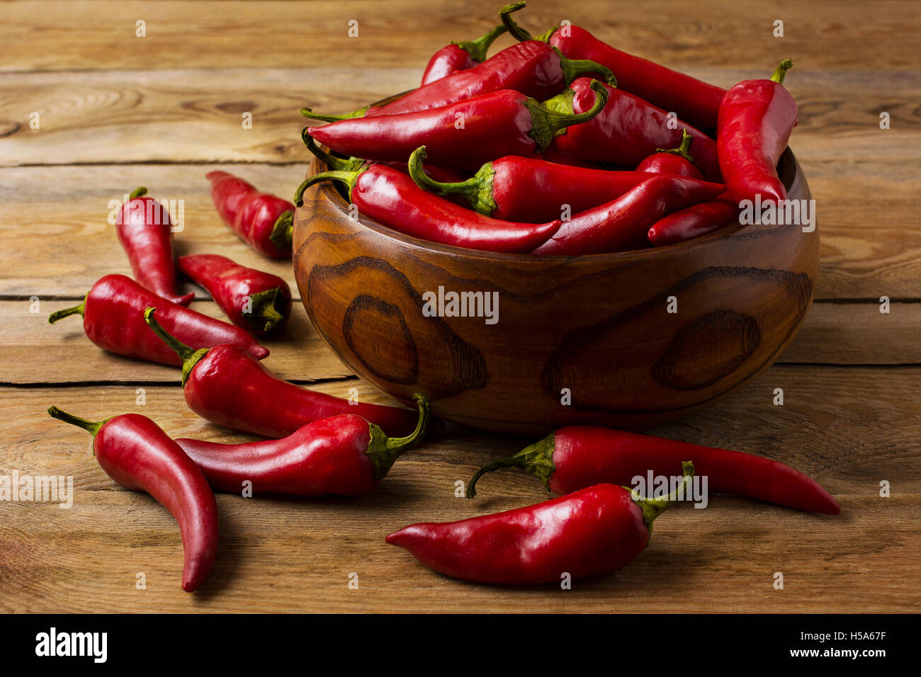 Red hot chili pepper in ciotola di legno. Il cibo piccante concetto. Foto Stock