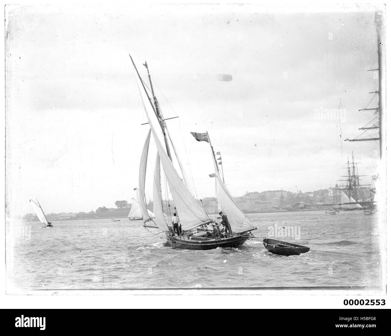 Uno yacht da corsa, probabilmente chiamato ISEA, sta navigando sul porto di Sydney. Questa immagine cattura l'azione e la bellezza della scena delle corse di yacht in uno dei porti più iconici dell'Australia. Foto Stock