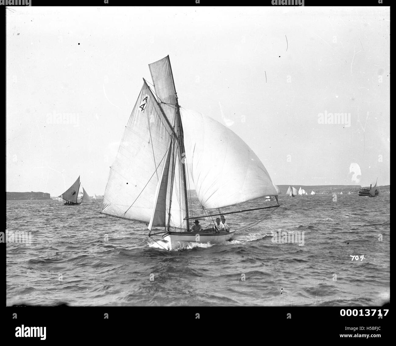 Il centreboarder di 24 piedi, SNOWDROP, è visto guidare la flotta durante una gara da South Head, nel porto di Sydney. L'immagine cattura l'azione della gara, evidenziando la natura competitiva della navigazione nel porto. Foto Stock