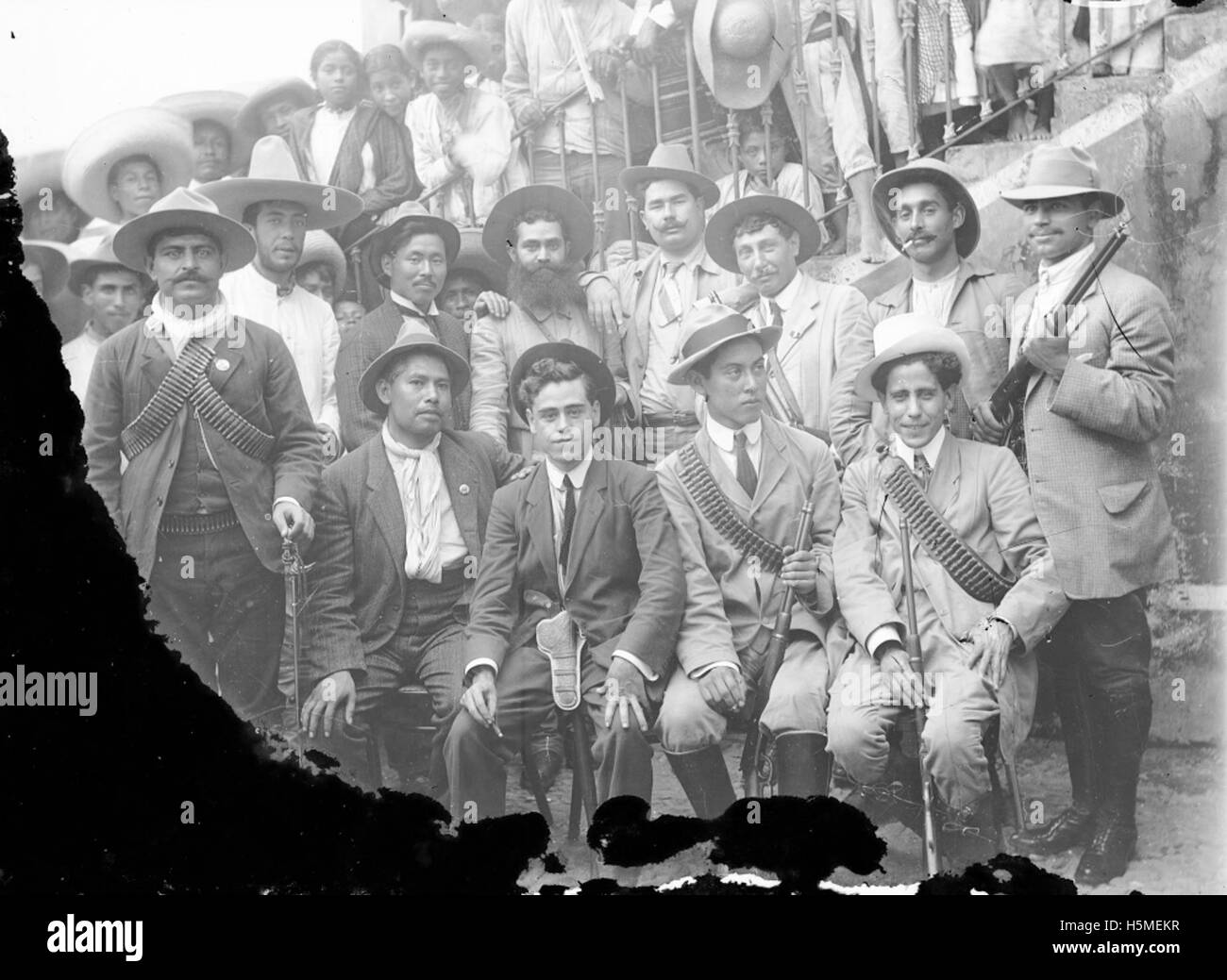 Questa fotografia raffigura un gruppo di uomini armati, forse soldati, che trasportano armi da fuoco. L'immagine riflette l'abbigliamento militare e le armi, catturando un momento di preparazione armata o di fidanzamento. Foto Stock