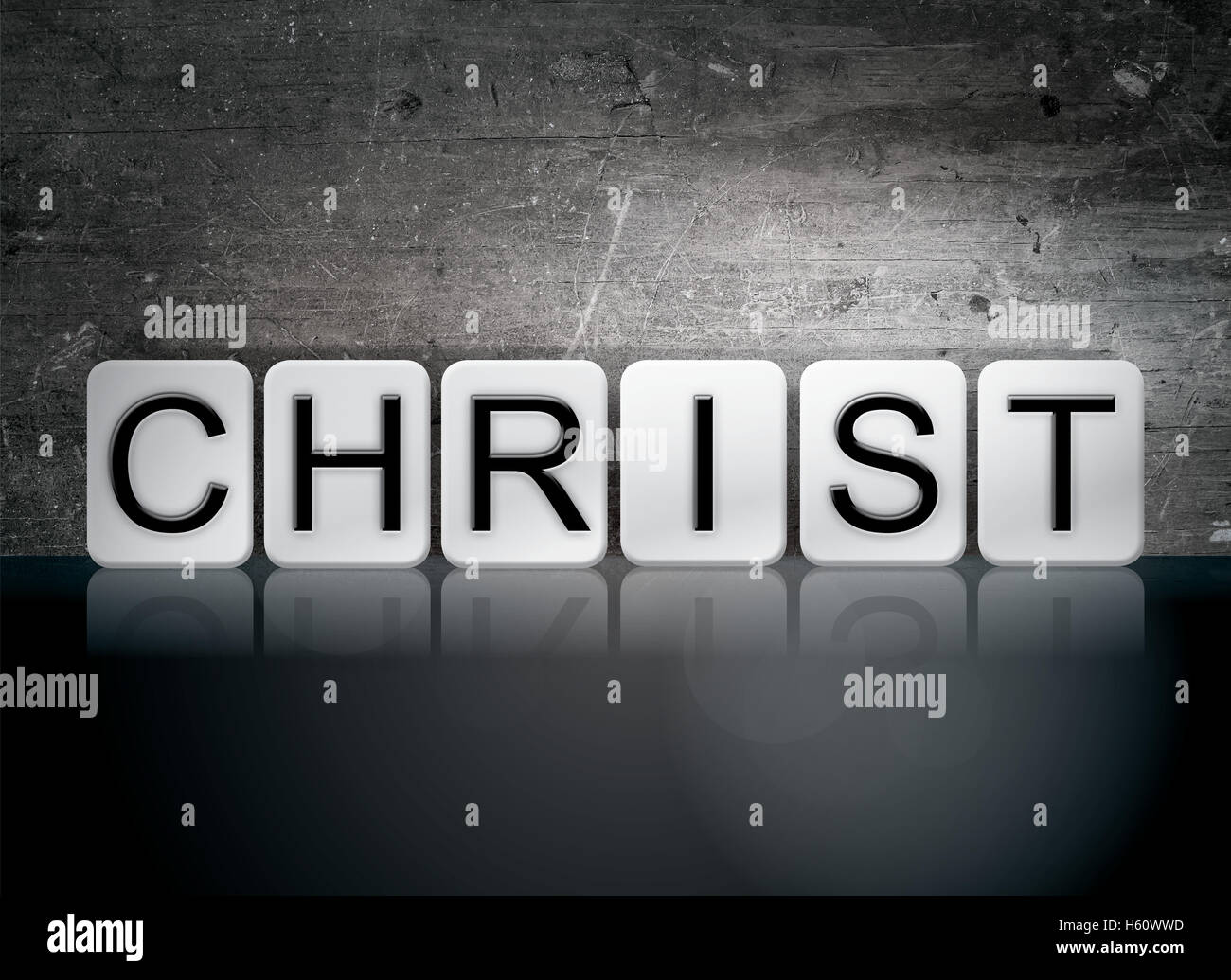 La parola "Cristo", scritto in piastrelle bianche contro un oscuro vintage grunge background. Foto Stock