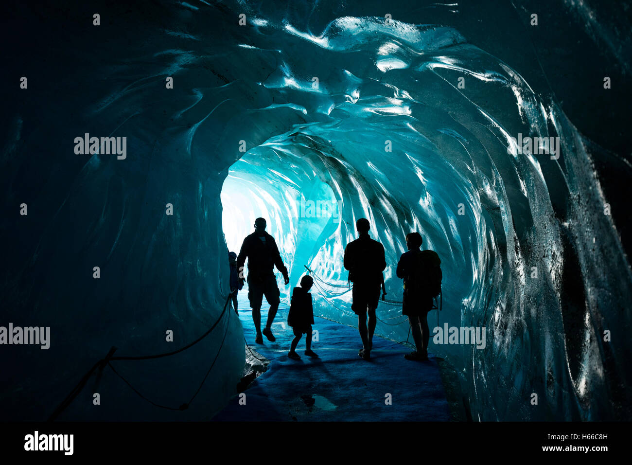 I turisti all'interno della caverna di ghiaccio in Mer de Glace ghiacciaio, Montenvers. Valle di Chamonix, sulle Alpi francesi, Francia. Foto Stock