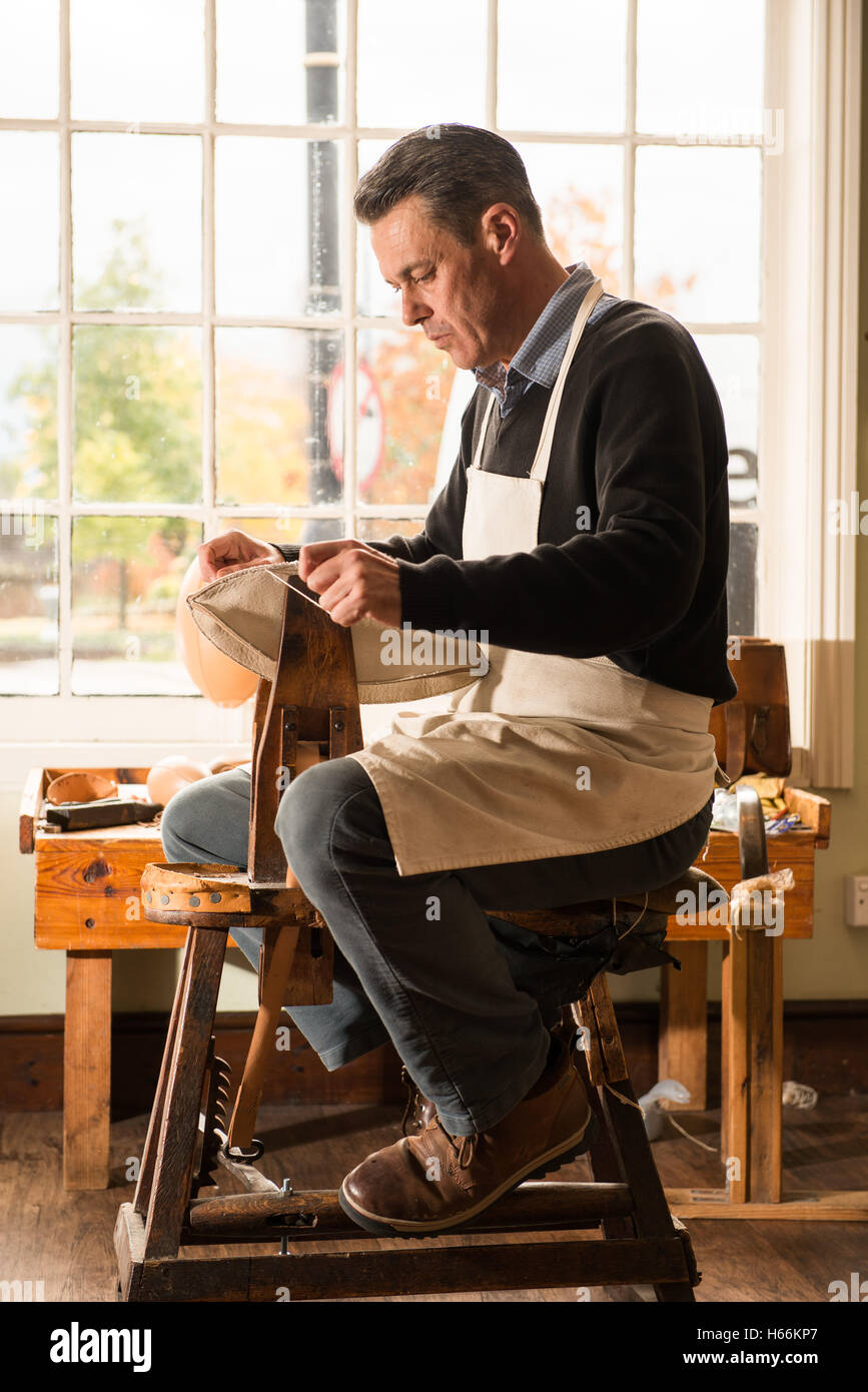 Una sfera tradizionale stitcher rendendo un cuoio rugby palla in Webb Ellis Rugby Football Museum, Rugby, Warwickshire, Regno Unito. Foto Stock