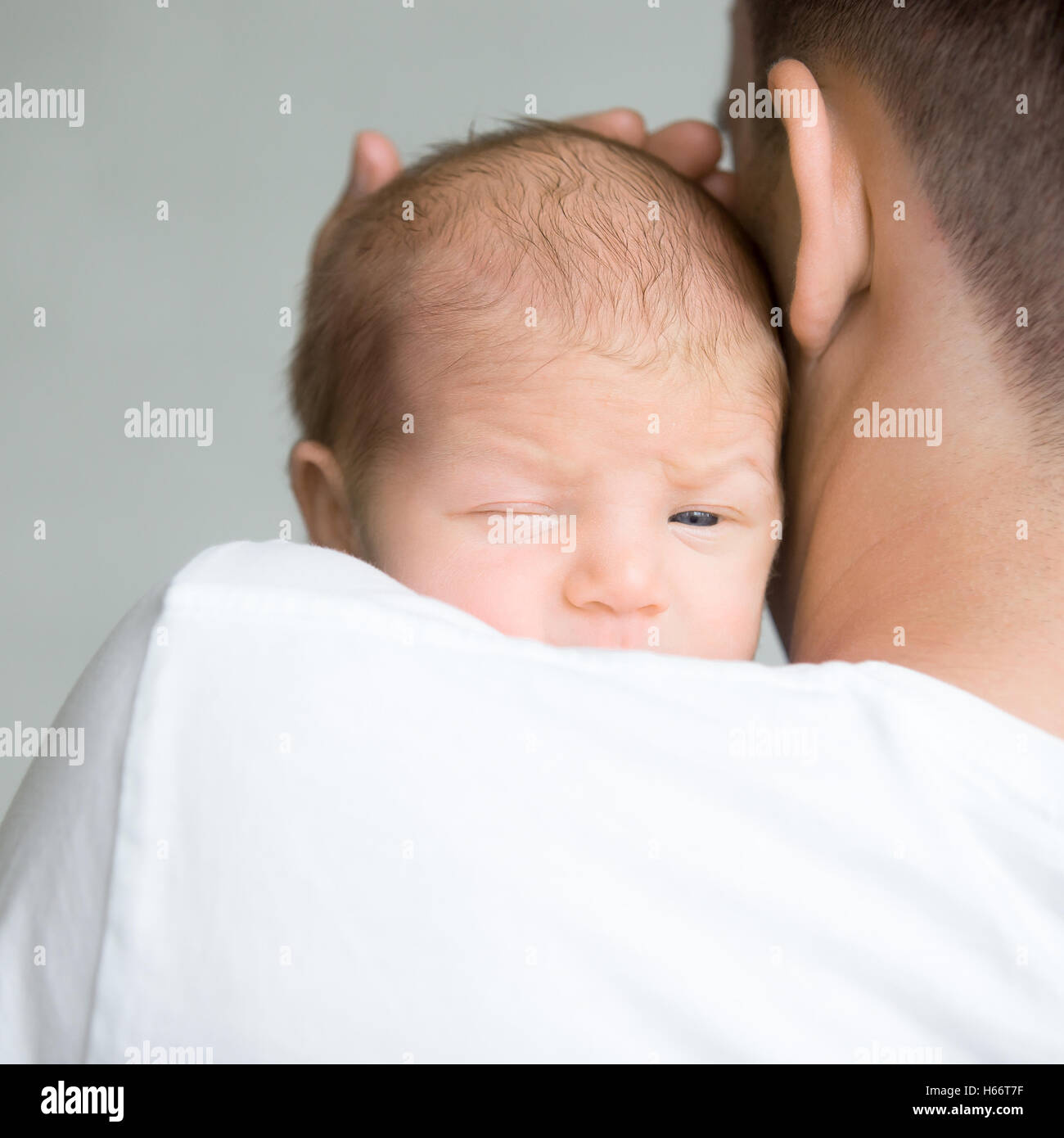 Ritratto di un neonato carino tenere a padre spallamento Foto Stock