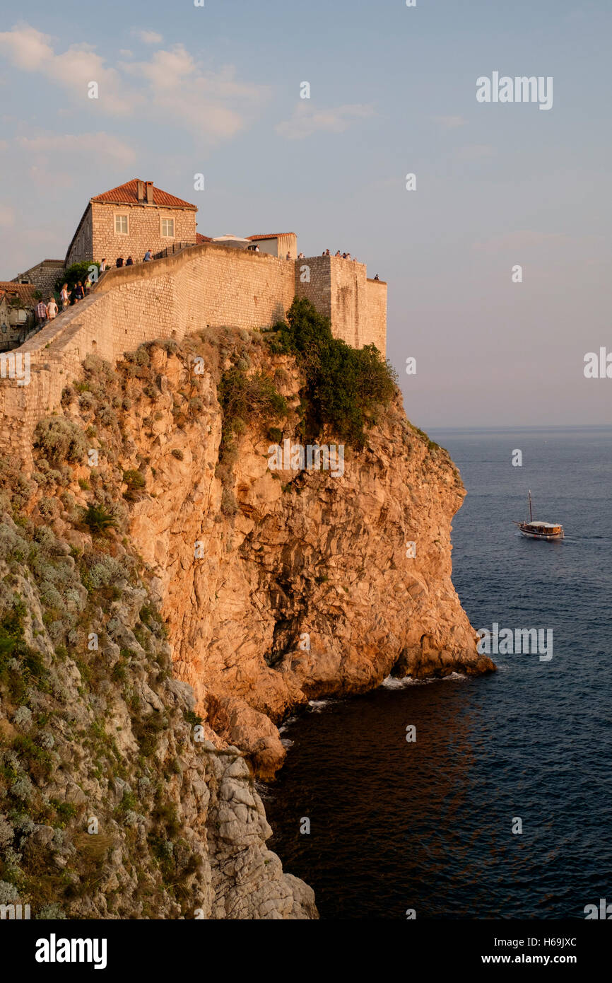 Le mura cittadine di Dubrovnik incandescenza al tramonto. Il sito Patrimonio Mondiale dell'UNESCO della Città Vecchia di Dubrovnik è conosciuta come la perla del Foto Stock