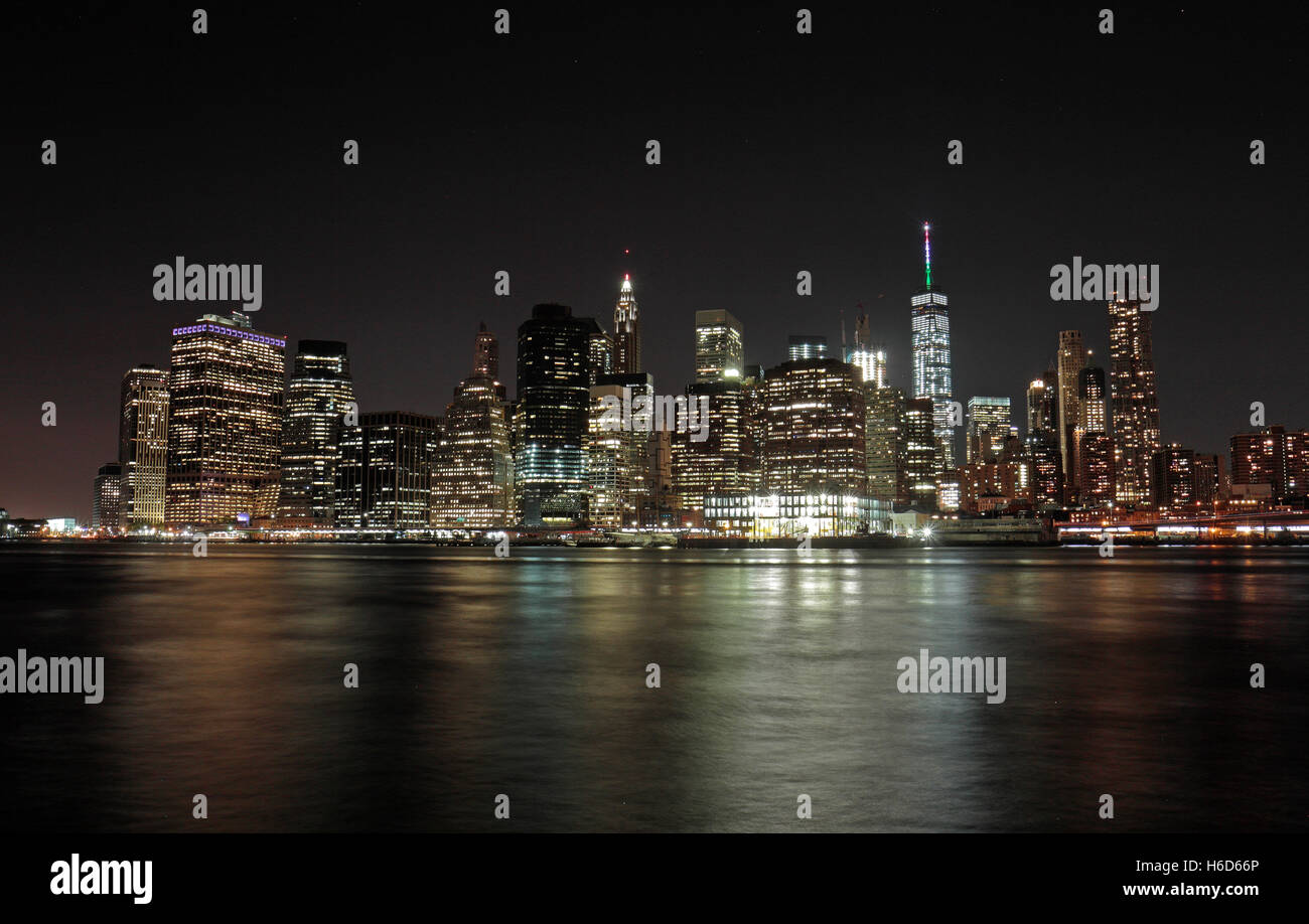 Un tempo di notte vista di Manhattan inferiore attraverso l'East River da Brooklyn, NY, Stati Uniti. Foto Stock