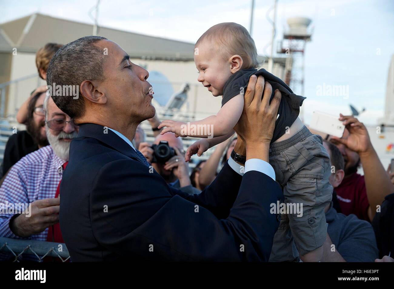 Stati Uniti Il presidente Barack Obama tiene un bambino mentre saluto le persone sull'asfalto all'arrivo all'Aeroporto Internazionale di San Francisco il 12 febbraio 2015 a San Francisco, California. Foto Stock