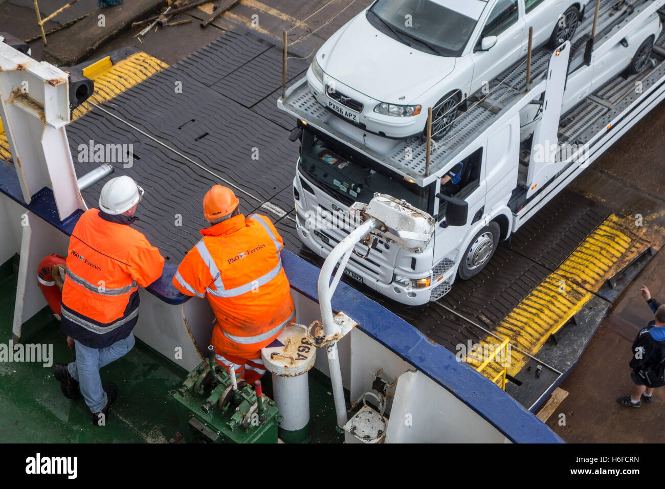 Nave di membri di equipaggio guardare carrello con vetture su auto vettore rimorchio imbarco ferry boat di P&O North Sea Ferries Foto Stock