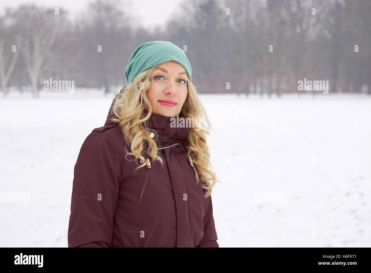 Donna in coperta di neve il Parco in inverno Foto Stock