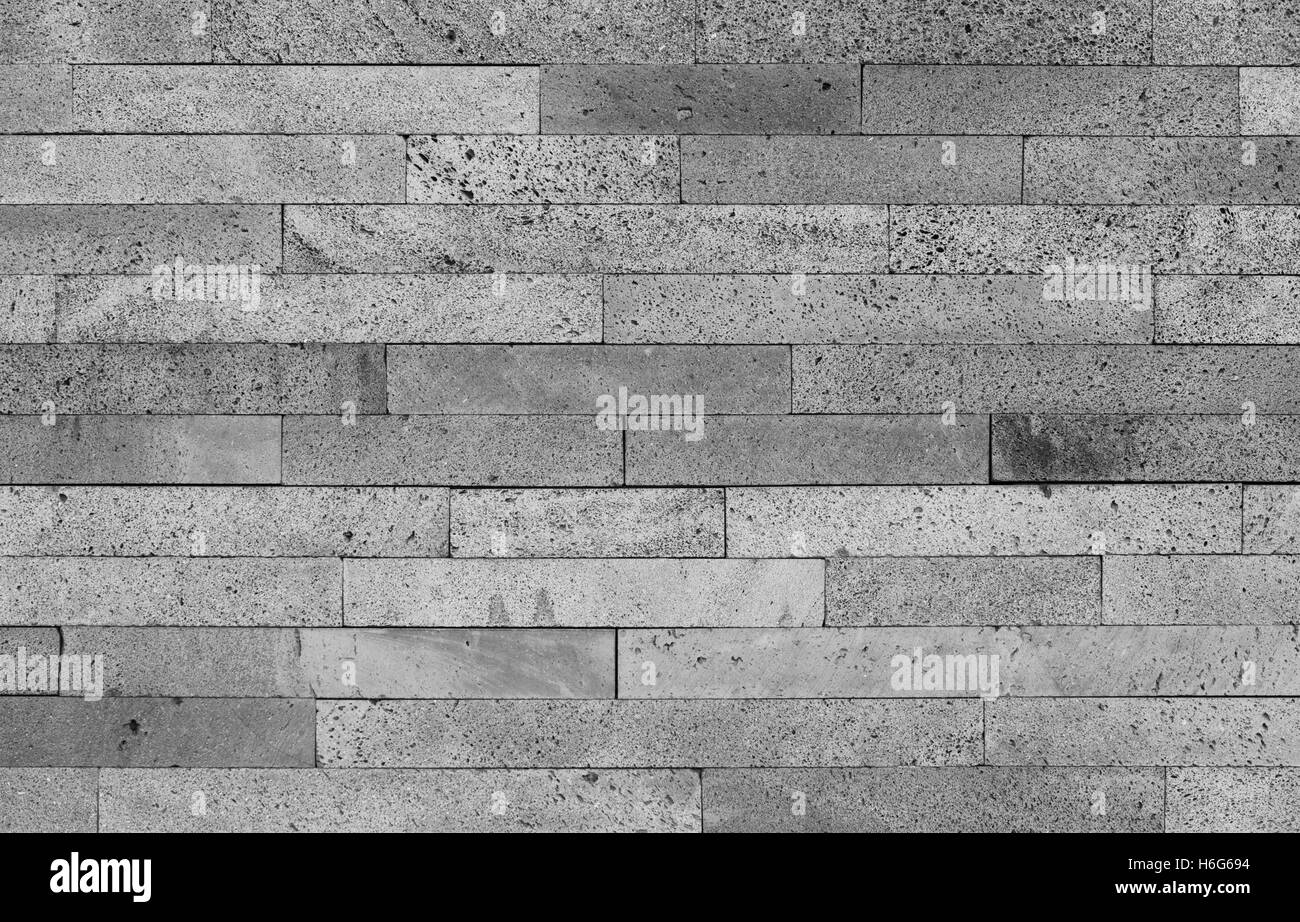 Pietra vulcanica di parete di mattoni di sfondo in bianco e nero. Posizione orizzontale Foto Stock