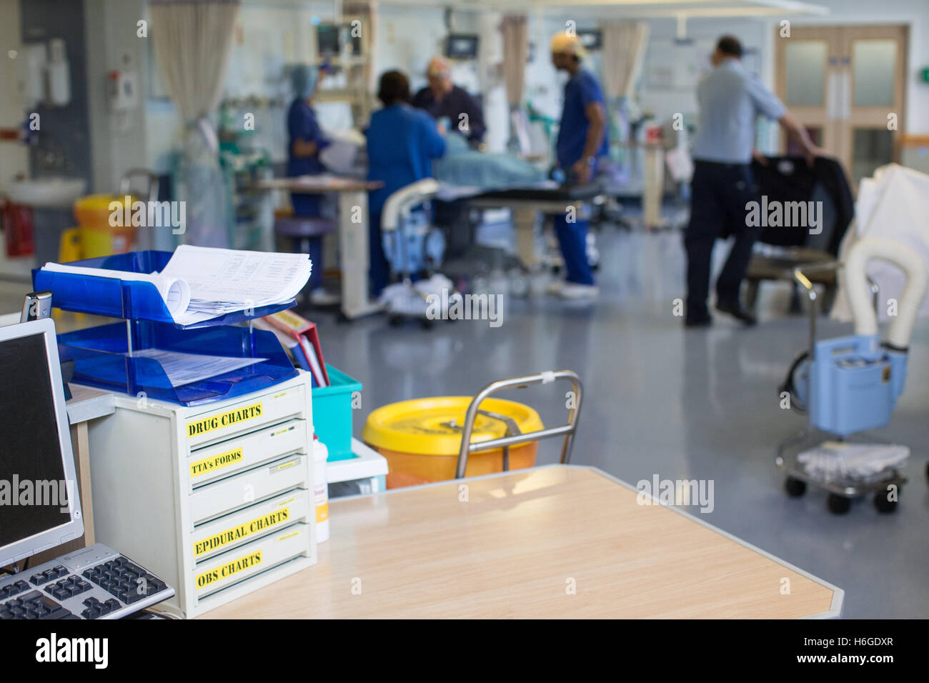 Workstation in ospedale in un reparto con gli infermieri che frequentano per rispondere alle esigenze dei pazienti Foto Stock