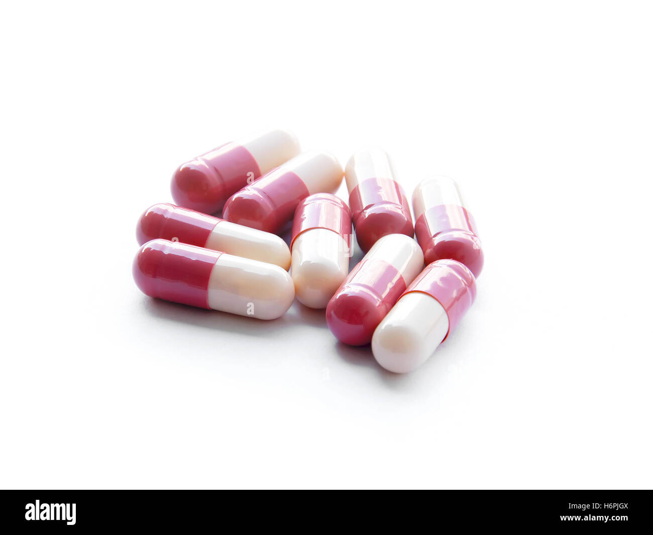 Si è chiusa la medicina capsula rosa isolato su sfondo bianco Foto Stock