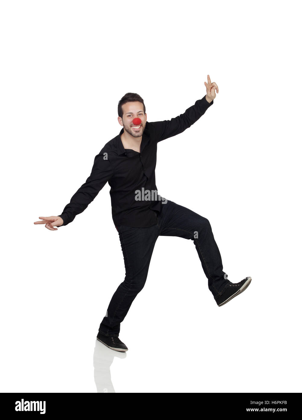 Giovane uomo ballando con clown naso su sfondo bianco Foto Stock